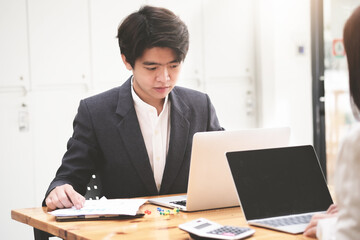 businessman and businesswoman using computer laptop for research or Marketing development in budget of company.