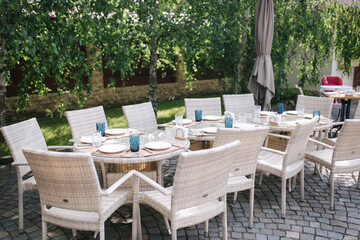 Served table set at summer terrace. Cutlery in cafe. Green background