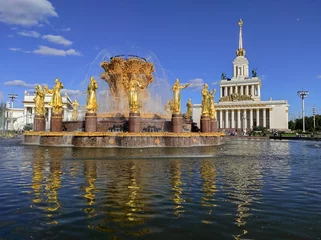 Poster Exhibition of Achievements of National Economy (VDNH park) is popular tourist landmark in Moscow, Russia. Beautiful golden fountain "Friendship of Peoples".  © Yuliya