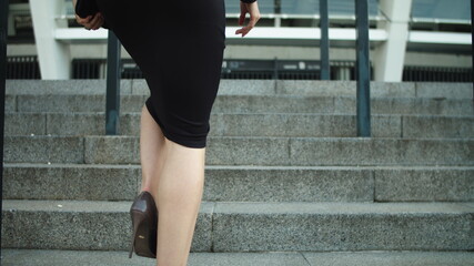 Portrait elegant woman legs going upstairs in stylish shoes outdoors