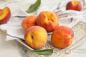 Naklejka na ściany i meble Tray with ripe peaches on table, closeup