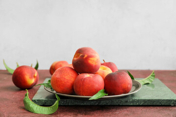 Naklejka na ściany i meble Tray with ripe peaches on table