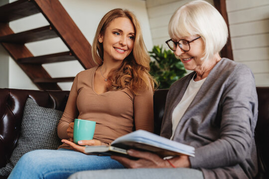 Low angle view of middle aged woman spending time with her senior mother at home