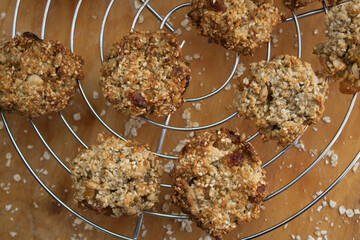 Oatmeal cookies on metal cooling rack. Wooden background
