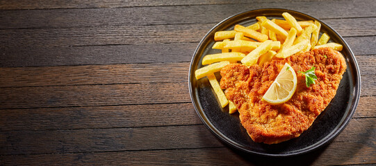 Crumbed fried fish or schnitzel with French fries