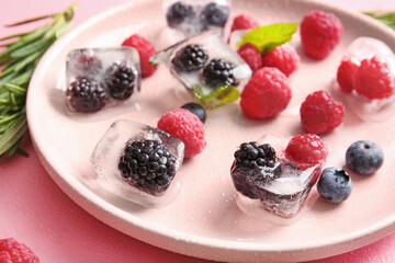 Plate with berries in ice on color background, closeup
