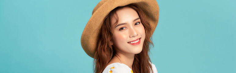 Fashion portrait pretty woman in straw summer hat over colorful blue background