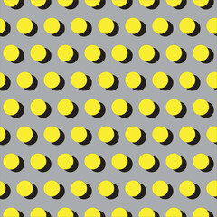 Yellow and black dots seamless pattern on grey background. Polka dot pattern.