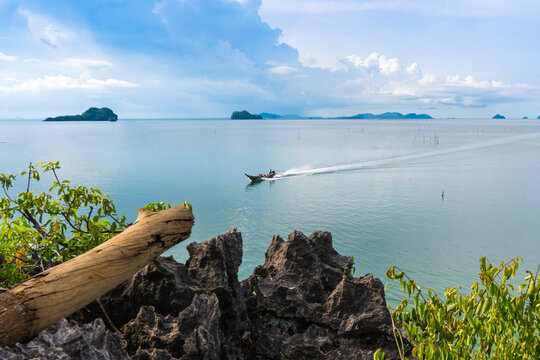 A long-tail boat is  bringing tourists to see the sea scenery at Ao Khram village, Amphoe Sawi, Chumphon province.