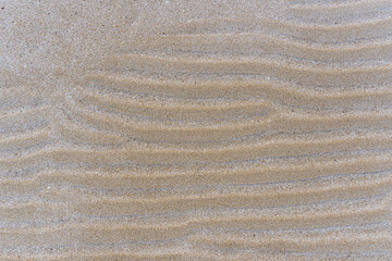 Fototapeta na wymiar The waves of sand on the beach.