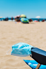 Fototapeta na wymiar mask in the armrest of a deck chair on the beach