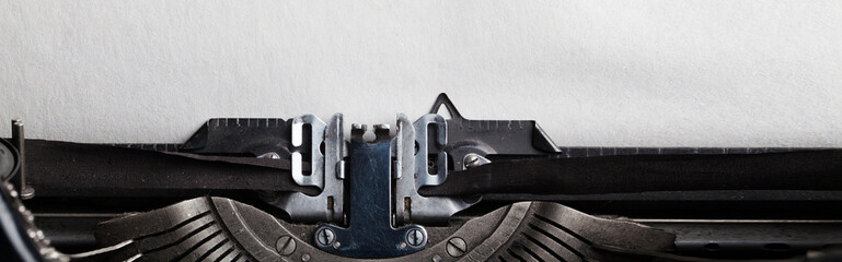 Empty sheet of a paper for your text inserted into a typewriter. Website header or banner