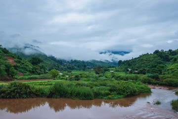 The river with beautiful foggy mountains and nature view in countryside