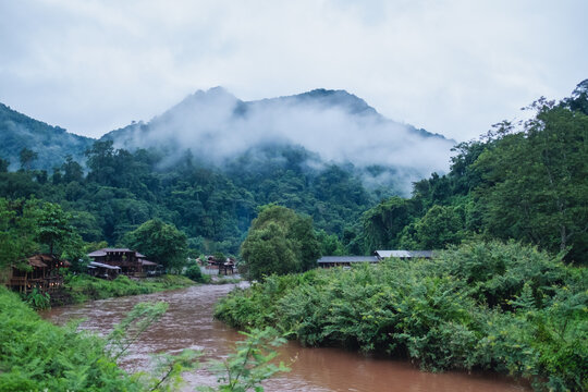 The river with beautiful foggy mountains and nature view in countryside