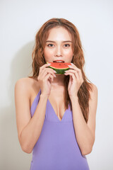 Slice of summer goodness. Beautiful young woman holding slice of watermelon and smiling