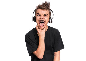 Teen boy in headphones with spooking make-up making Rock Gesture, isolated on white background. Teenager in style of punk goth dressed in black screaming and shouting, doing heavy metal rock sign.