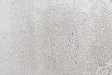 Cracked surface texture. Many small cracks on white paint. Old metal wall. Perfect for background and design.