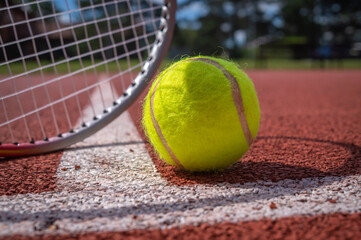 Tennis scene with white line, ball and racquets