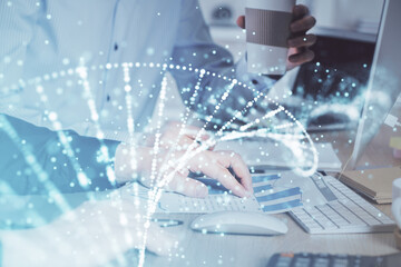 DNA hologram with businessman working on computer on background. Concept of bioengineering. Double exposure.