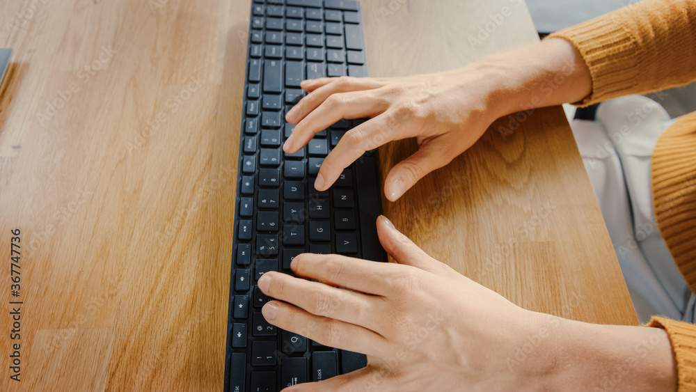 Aufkleber top view close-up shot of a female hands typing on a keyboard. beautiful young female specialist sit