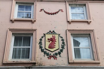 A  view of dragon pargeting on the exterior wall of a house in Wales, Great Britain.