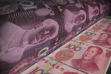 Yuan banknote money printing process. Bank press machine to print money. Concept of economic...