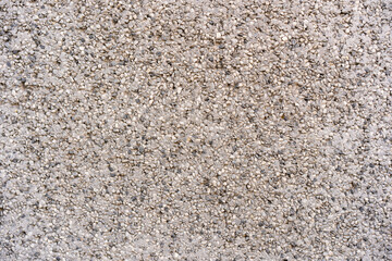 Textra de pared de pequeñas rocas en tonos blancos, negros, grises y ocres