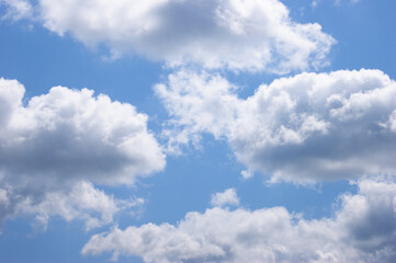 Naklejka na ściany i meble Light blue sky background with clouds.