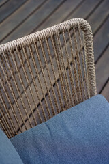 Fototapeta na wymiar Close up details shots of arm chairs standing on a wooden terrace deck 