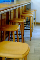 Bar chairs made from wood with no people sitting down