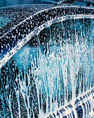 Soap on a car window while washing.