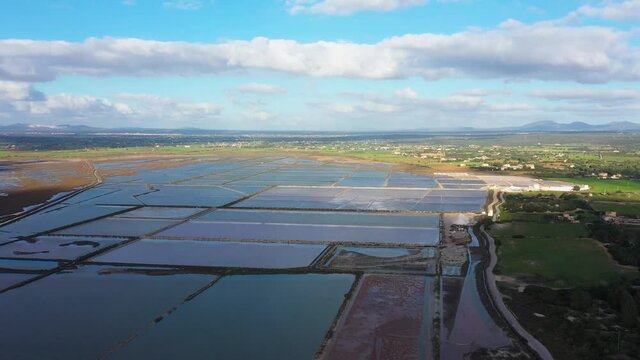 Salt evaporation ponds, salterns or salt works near the Colonia de Sant Jordi in Mallorca, view from drone