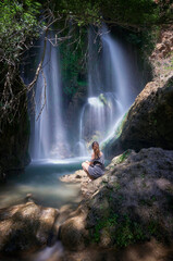 Photograph of a woman in the "Baño Chico" waterfall in Durcal, Granada.