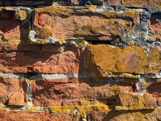 Close-up of an old broken red brick wall. Texture, pattern, vintage.