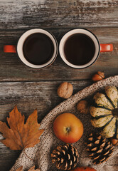 Cups and autun accessories on wooden background.
