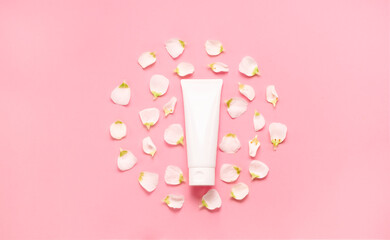 Delicate skin care cosmetic feminine flatlay. Top view Creative composition of face cream ,glass bottles and jars with cosmetic and flowers leaves