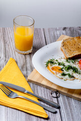 Fried eggs on a platter served with parsley and tomatoes.