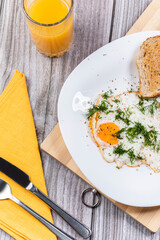 Fried eggs on a platter served with parsley and tomatoes.