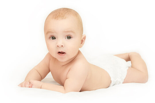 Little pretty kid. Lying at home. White background. Happy expression. Male child portrait. Mother care. Wearing diaper. Funny sensitive human. Horizontal banner with copyspace. Look at camera