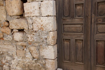 old wooden door in stone wall