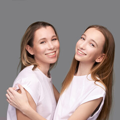 Elder mother and teenager daughter hug. Happy family portrait. Similar smile. Next generation love. Single mom. Mature parent. Smiling people group. Attractive posing together. Two hand connection