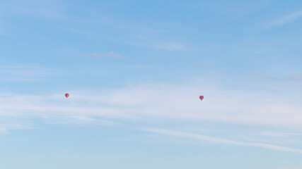 two red hot air balloon flying in the sky