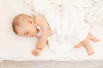 Small baby girl 6 months old sleeping in a white bed, healthy baby sleep