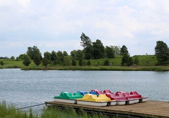 The colorful paddle boats on the dock at the lake.