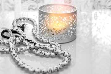 Prayer time. candle and rosary on the table