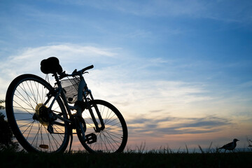 Fototapeta na wymiar Pushbike silhouette against the evening sky