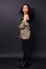 Young beautiful Asian transgender woman against black background