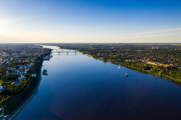 a panoramic view of the big blue river and the ships sailing along it filmed from a drone