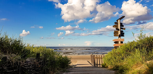 View of Jurmala coast with sea and pillar with direction signs. - obrazy, fototapety, plakaty