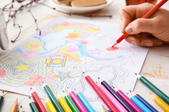 Woman coloring picture at table
